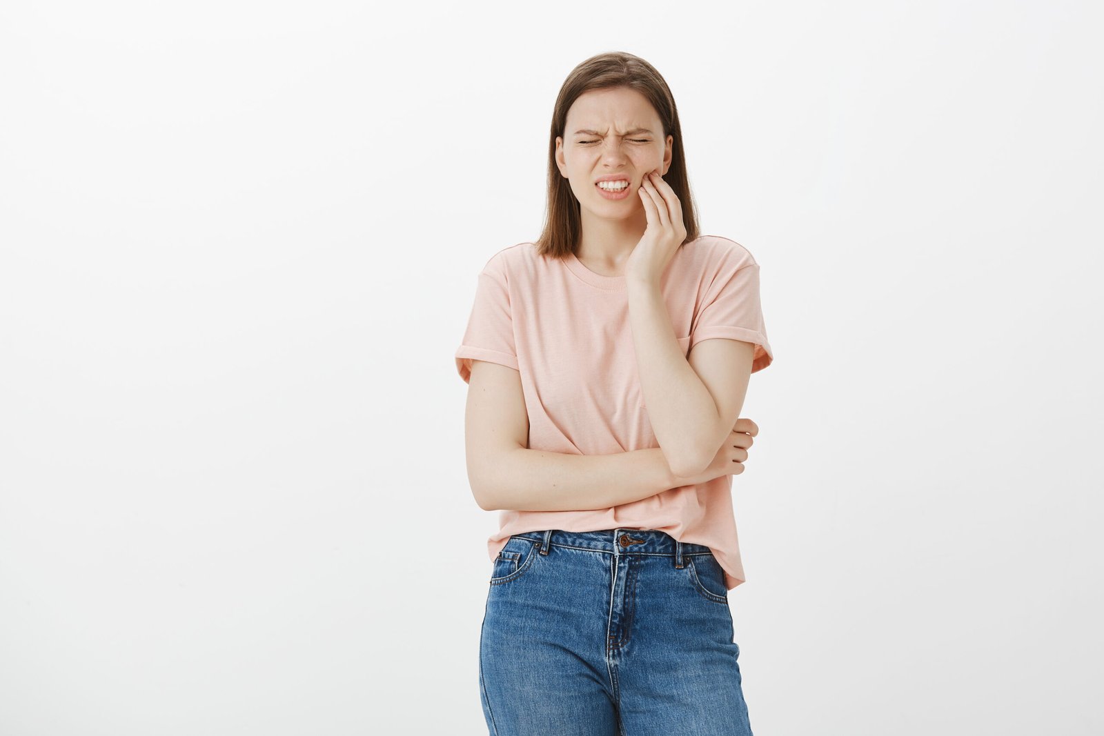 A woman demonstrating a common reason for an Emergency Dental Visit in Beverly Hills.